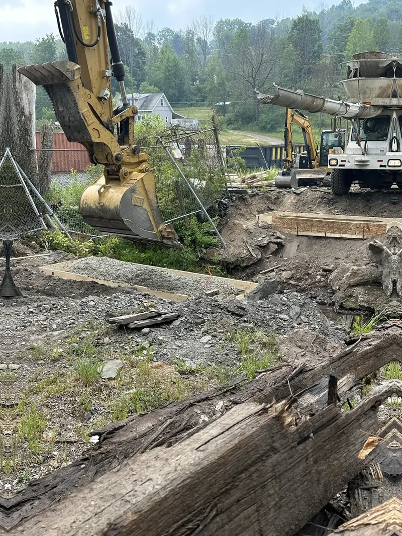 Excavator removing the old timber structure of a bridge during demolition