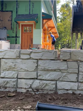 Magnum Stone retaining wall running in front of a home