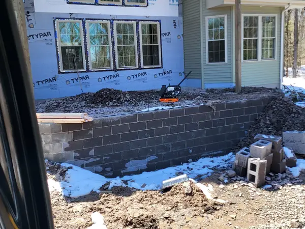 Block walls for the deck foundation seen from the excavator cab
