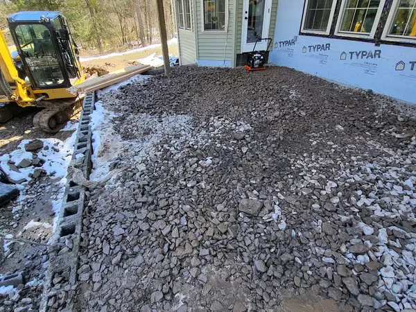 Stone fill being spread inside the new block walls
