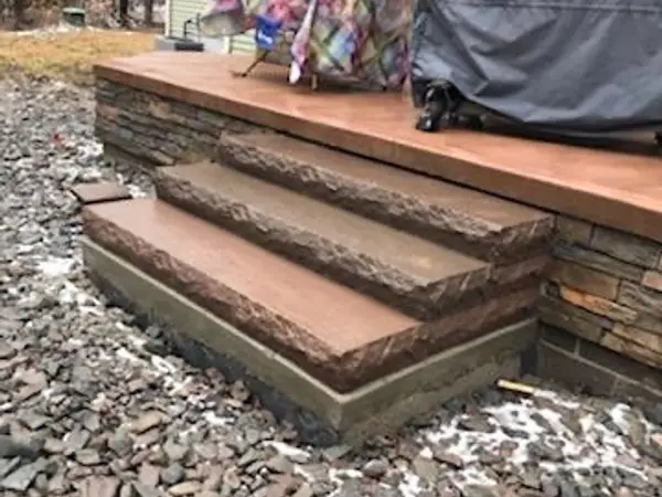 Concrete deck steps with a stacked stone face